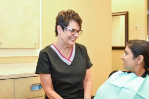 Hygienist talking with patient